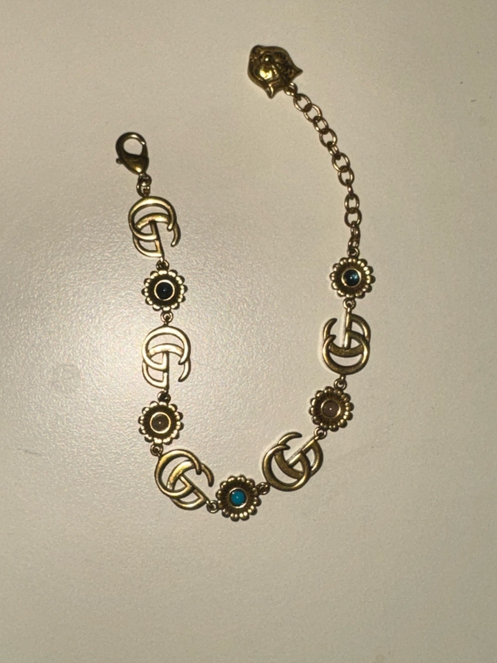 GUCCI Gold-Tone Floral Link Bracelet with Turquoise and Black Accents